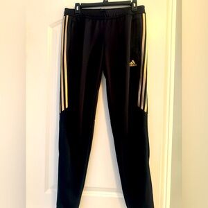 Unisex Adidas soccer pants black and gold.